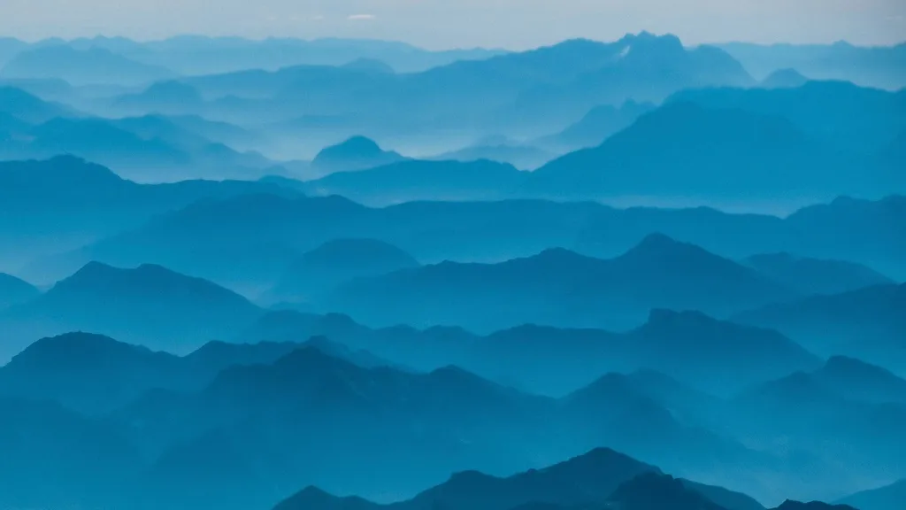 Layered blue mountain ridges fading into morning haze